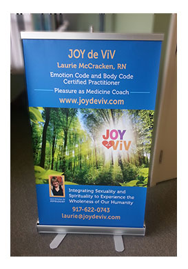 Table top vertical banner opened with fold-up stand.